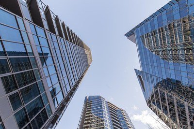 Glass towers seen from below, against the sky.
