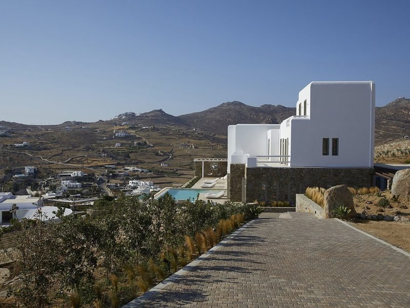 The estate seen from the approach road, pool terrace above the hillside, Tourlos