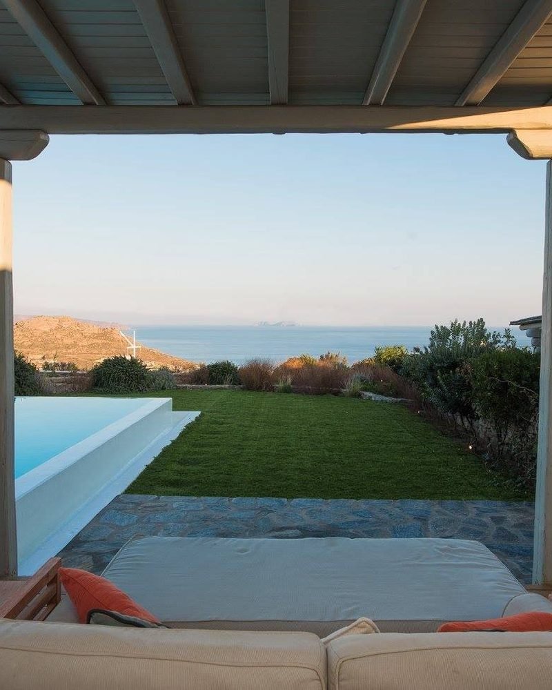 Sea view framed by the veranda, with lawn and infinity pool edge, Kalafatis / Ano Mera