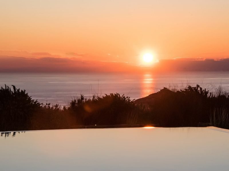 Sunset over open sea seen across the infinity pool's edge, Kalafatis / Ano Mera