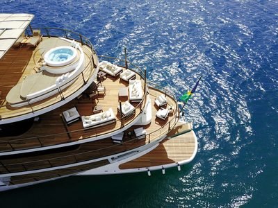 Aerial over the curved teak aft decks, spa pool and swim platform astern