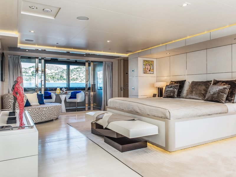 Master suite with wide bed and glass doors opening to a private terrace