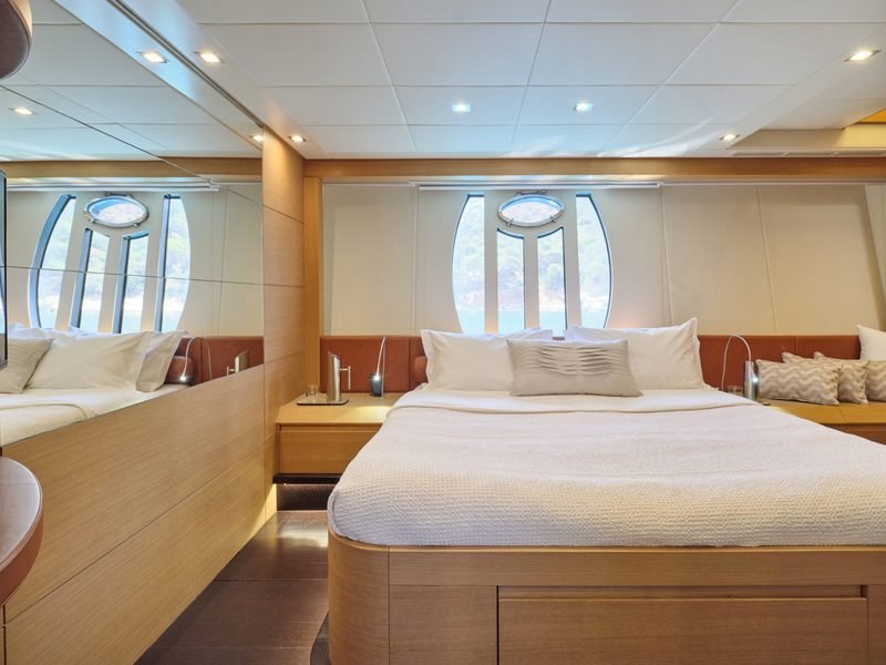 Master cabin with wide berth, curved hull windows and mirrored bulkhead