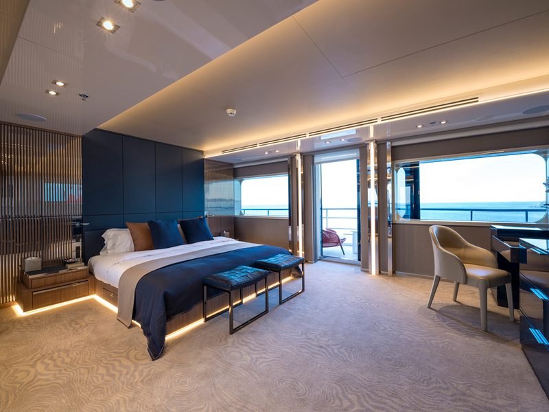 Master suite with navy joinery, concealed lighting, writing desk and private sea-view balcony