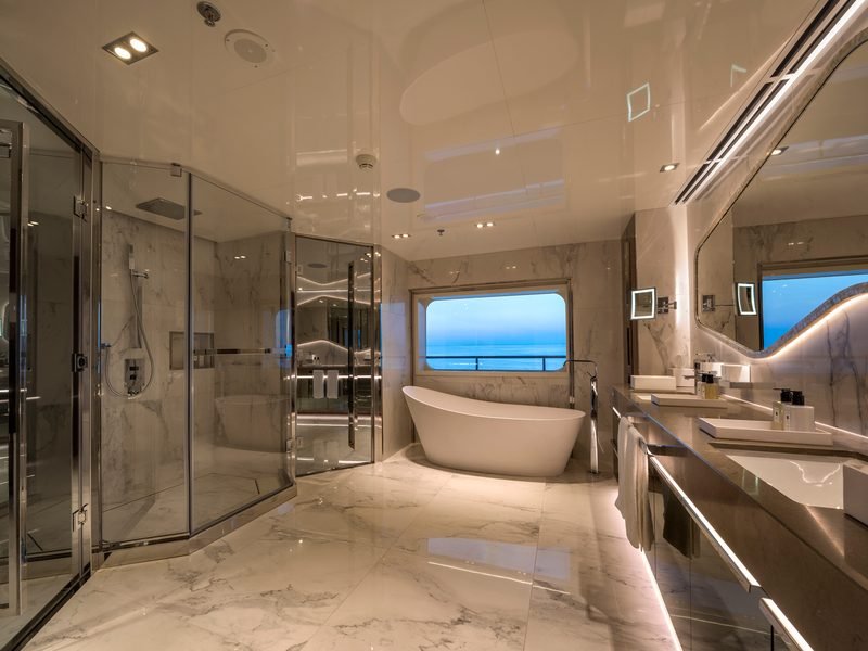Master bathroom in Calacatta marble with freestanding tub set into a sea-view window