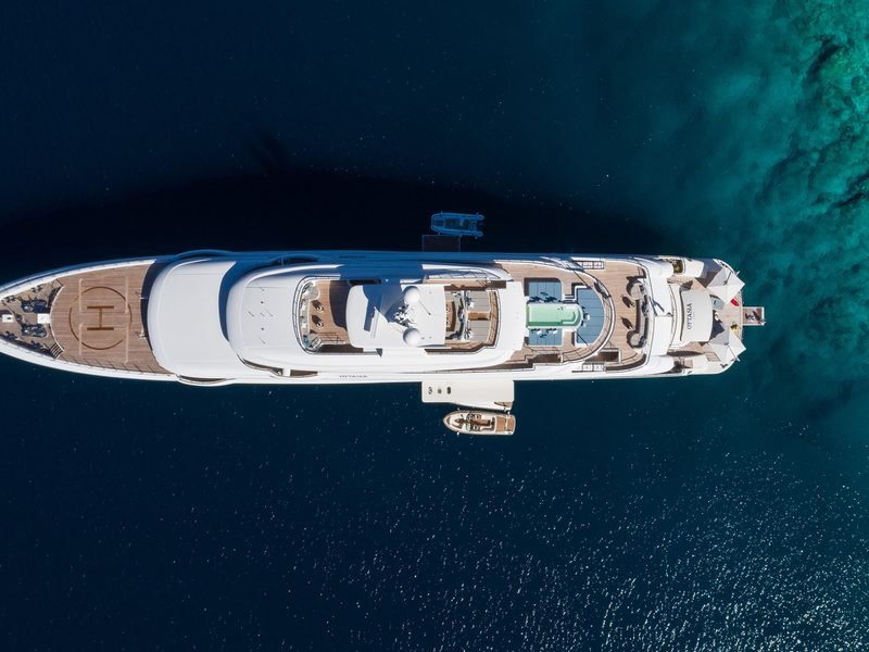 Aerial of the yacht at anchor, helipad circle marked on the teak foredeck