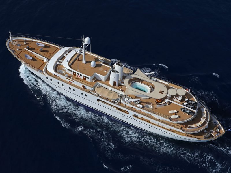 Aerial of the yacht underway, teak decks, sundeck jacuzzi and three jet-skis aft
