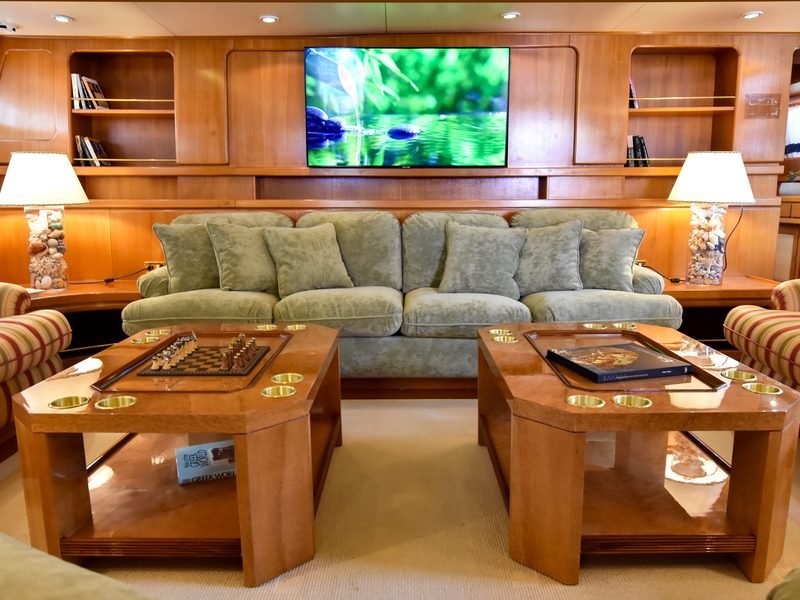 Main saloon with sage suede sofas, twin burl games tables and chess set